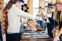 People shopping for hats at custom hat bar