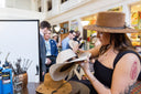 Woman branding a cowboy hat at private event