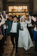 couple wearing wedding hats
