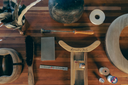 Collection of hat making tools and materials on a wooden surface
