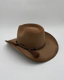 Angle side profile of camel felt cowboy hat with curved brim, braided band, and mountain branding, Gem Hats Denver