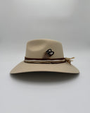 Side profile of ivory wool felt hat with curved western brim, leather and silk bands, and a decorative feather, Gem Hats Denver