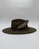 Detail of leather hat band, upcycled green silk, and two feathers on moss wool felt hat, Gem Hats