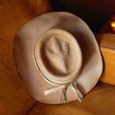 Wool felt hat on leather couch